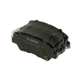 Three-quarter angle of the shrink-wrapped pad pair, Bosch logo and part number impression visible on the exposed side of the top pad, retaining clip tab visible on the upper edge.