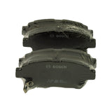 Two pads laid friction-side-up inside sealed plastic wrap, BOSCH wordmark printed on the friction surface and moulded 0 986 AB2 382 / 17401 / SBS / BNA143 markings visible on the exposed pad edge