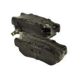Two pads stacked, one showing the integrated acoustic wear-warning spring clip on the backing plate