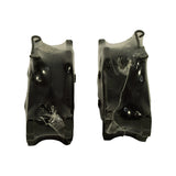 Edge view of the pair stood on their backing plates, showing friction material thickness and the formed retaining clip at the top edge