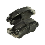 Three-quarter angle of two shrink-wrapped pads showing complex contour of backing plate with cast lugs and machined seat for caliper carrier