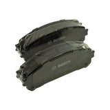 Three-quarter angled view of the same two shrink-wrapped pads, highlighting the powder-coated black backing plate finish and ventilation slot across the friction face.