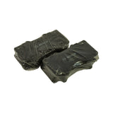 Angled view of both shrink-wrapped pad pairs side by side, showing the complete set of four front pads ready for installation