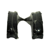 End-on view of both pads stood on edge showing friction material thickness, backing plate profile, and pad ear geometry through the shrink wrap