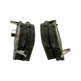 Edge-on profile of both pads showing friction material thickness, chamfered leading edge, two horizontal friction slots, and stainless steel anti-rattle retention clips fitted to each pad