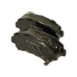 Pair of shrink-wrapped pads laid face-up on white background, showing pad outline with tapered ear corners and front-face Bosch branding