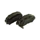 Overhead pair of sealed pads side by side, wrap fully intact, showing mirrored left/right pad shape typical of a front axle set