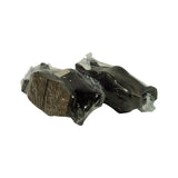 Angled view of two bagged pad pairs side by side, one pair showing the friction-material face with moulded 'BOSCH' pattern in the compound, the other showing the smooth coated backing plate side