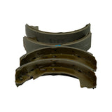 End-on view of stacked shoes — top shoes showing edge profile of the lining with 12345 stamping, bottom shoes showing the gold-plated arched steel platform with web reinforcement and parking brake lever cut-outs