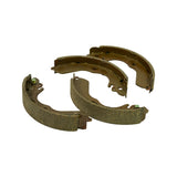 Loose arrangement of all four shoes showing both webs and lining faces, anchor cutouts at the shoe ends and the handbrake-lever pivot tab