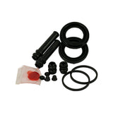 Kit contents laid out on white background, three-quarter view. Two corrugated dust boots (tall, ribbed), two large cupped piston seals, two flat O-rings, two smaller guide pin grommet boots, two bleed nipple caps, and a transparent sachet containing red/pink assembly grease.