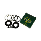 All kit components laid out next to the open green FrenKit box, showing full contents: two dust boots, two piston seals, two spring clips, bleed screw cap, and two small washers.