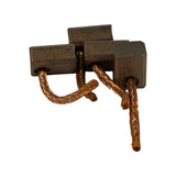 Two pairs of brushes stacked, showing end-on profile. Top surface shows the copper lead attachment holes and lead exits. One pair has woven braid leads; the other pair has stiffer twisted copper leads.