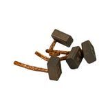 Four brushes scattered loosely, top-down view. Variation in lead style between pairs clearly visible — two with flexible woven braid, two with stiff solid copper wire leads. Carbon block dimensions consistent across all four.