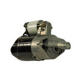 Starter motor, front-left three-quarter view emphasising the drive end nose housing and pinion engagement snout. Cast aluminium bracket with triangular ribbing visible. Solenoid terminals at upper left.