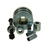 Kit contents from front-facing angle: pulley upright showing double-groove profile and 22mm bore with brass-toned bore insert; hardware laid out — bolt with large flat washer, small ring spacer, angled cone washer, two tubular sleeve adapters, and a short cylindrical spacer.