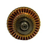 End-on view of the commutator end showing approximately 25 copper commutator bars separated by insulating mica segments, arranged in a disc around the shaft bore.