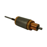Opposite-angle three-quarter view of armature showing laminated steel core body, copper end windings with gold/amber varnish coating, and both shaft ends. Commutator clearly visible at right.