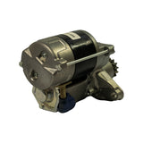 Three-quarter rear view from the commutator end, showing the end-cap with cross-head screws, the gold-toned solenoid end cover, drive pinion at upper right, and blue terminal cap. Clearly a gear-reduction pre-engaged type starter.