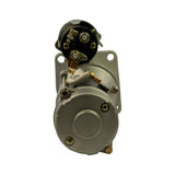 Commutator end view looking directly into rear of motor. Brush holder assembly and solenoid cap visible from top. Square mounting flange at rear with four unthreaded bolt holes. Central commutator end cap with securing screws.