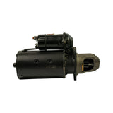 Drive-end view from side showing exposed pinion/Bendix drive with visible teeth seated in cast iron drive-end housing; copper brush contact at pinion nose visible