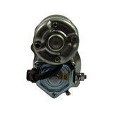 Rear/top view of motor showing circular end plate with three screws, and solenoid face-on with yellow '12V' sticker and main battery terminal stud visible.