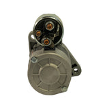 Drive-end (solenoid terminal end) face-on view. Two copper-plated solenoid stud terminals and blade terminal visible. Rear end cap with cross-pattern ribs and two mounting boss bolts.