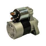 Front-right 3/4 view showing solenoid, copper terminals, and motor body from opposite angle to photo 2. Mounting flange geometry clearly visible.