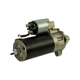 Rear three-quarter view showing commutator end cap with through-bolt arrangement, solenoid main terminal stud, and field wire connection at rear of motor can.