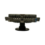 Edge-on profile view of the fan clutch showing the flanged water pump mounting plate (black finish), central drive spindle, and layered aluminium fin body with fan blade mounting tabs extending at periphery. Small blue foam packing pieces visible on tabs.