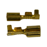 Two brass terminals laid on their side showing full profile: wire crimp barrel at one end, female spade receptacle at the other, with crimp serrations visible along the conductor grip