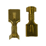 Two terminals photographed front and back showing the square blade entry slot, the raised dimple of the internal locking tab, and the Narva 'N' emblem stamped in the brass at the wire-crimp end