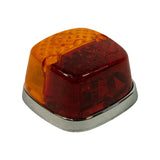 Opposite three-quarter angle showing lamp from amber-dominant side. 'MADE IN AUSTRALIA REG DES 3208' text legible on red lens. Chrome surround and base plate in good condition with minor age patina.