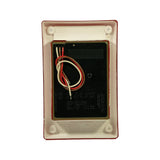 Rear of lamp module: black electronics housing with pre-wired leads (white, red, brown wires), white plastic recess-mount flange with four mounting bosses; moulded label reads 'Stop / Tail Module Multivolt 9-33 Volt' with wiring colour code: White=Negative, Red=Stop 9W, Brown=Tail 2W; 'Made in New Zealand' embossed on base of flange