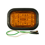 Lamp and grommet face-up, near-straight-on view; amber lens and full LED array clearly visible; 'MODEL 45700' legible on both long sides of grommet; wire leads visible at bottom.
