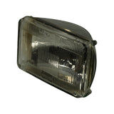Front three-quarter view of the sealed beam unit from driver's-left angle. Shows the ribbed rectangular lens, corner mounting tabs, and partial view of chrome reflector housing. 'WAGNER' embossing visible lower-centre; 'DOT' embossing lower-right; '1A1' and 'SEALED BEAM' text across the top.