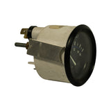 Three-quarter side view showing cylindrical zinc-alloy housing depth, U-bracket profile, spade terminal at top, and dial face with partial scale 12–16V visible. Label edge visible on housing.