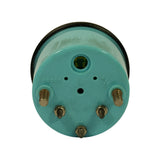 Rear face of gauge body (teal/turquoise plastic housing) showing five stud terminals labelled: RESET (upper left), L (upper centre), M/E (upper right), S (lower left), − (lower centre), + (lower right); circular bulb socket port at top centre labelled '3·4' with yellow bulb visible.