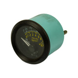 Three-quarter front-left view showing dial face with Susuki logo and dual PSI/kg/cm² scales, teal housing, and single stud terminal visible at upper right of housing.