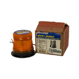 Three-quarter view of strobe unit removed from box alongside original box. Amber polycarbonate dome clearly visible with ribbed fresnel-style lens. Black circular flange base with two-wire hardwire lead visible. Box label confirms Amber / 12-80V configuration.