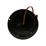 Underside of black circular flange base showing domed metal underside with central cable entry grommet and two small mounting holes on flange perimeter. Red and black wires exit via right-side cable clamp. No part number markings visible on base.
