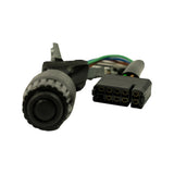 Close-up of rotary wiper-speed knob end and connector; knob is large-diameter cylindrical ribbed black plastic with central push-button; black rectangular 8-pin or 9-pin multi-pin connector shown face-on with gold terminal contacts visible in two rows; coloured wires (green, blue, orange, white, brown) visible between body and connector.