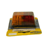 Three-quarter rear/right view of blister pack, card reversed showing Hella logo, barcode and label text mirrored. Lamp in blister shows amber section prominent from this angle.