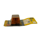 Side view from amber end showing rectangular lamp profile in blister, card bent open revealing label and Hella logo on rear of card.