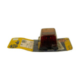 Side view from red end showing rectangular lamp profile, black rubber base, centre screw visible. Card bent back; Hella logo and label text visible on rear.