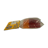 Side/profile view of the bagged lens lying flat on white background. Lens depth and slight curvature visible. Card header with Hella logo and 'Automotive Electrical Equipment and Accessories' text visible at left. Amber and red zones clearly distinguishable through packaging.