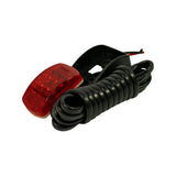 Side profile of fully assembled unit showing red LED lamp head mounted to black bracket with coiled cable extending to bare wire ends. Dimple-pattern red lens face visible.