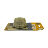 Side profile of lamp on card — clear dome lens prominent above flat black base, card label readable from this angle. General shelf wear and soiling to card visible.