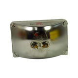 Rear face of lamp from slightly elevated angle showing the full width. Both brass spade terminals visible centrally. Stamped markings '12V50W / 4651 / JAPAN' and circular marks visible in red on upper portion of reflector. Reflector metal has minor surface oxidation consistent with age.