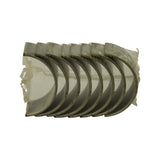 Top-down view of the sealed plastic sleeve containing eight curved steel-backed bearing half-shells nested in a row, bearing surfaces facing up